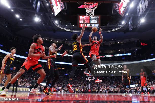 Anunoby of the Toronto Raptors drives to the net and puts up a shot over De'Andre Hunter of the Atlanta Hawks during the first half of their NBA game...