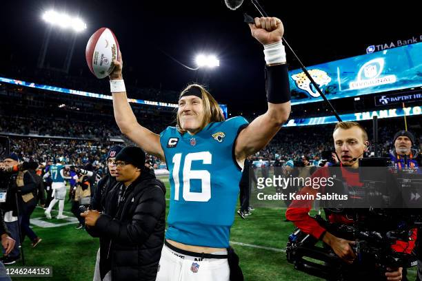 Trevor Lawrence of the Jacksonville Jaguars celebrates on the field after beating the Los Angeles Chargers in an NFL wild card playoff football game...
