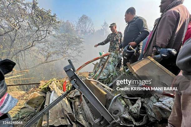 Rescuers gather at the site of a Yeti Airlines plane crash in Pokhara on January 15, 2023. - An aircraft with 72 people on board crashed in Nepal on...