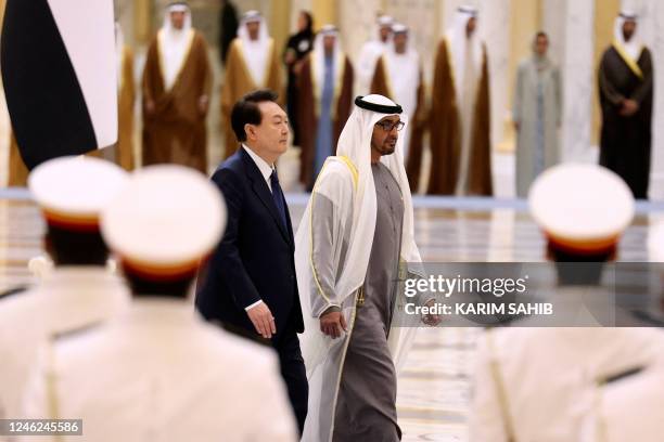 S President Sheikh Mohamed bin Zayed Al-Nahyan walks alongside South Korea's President Yoon Suk-yeol during a welcome ceremony at the royal palace in...