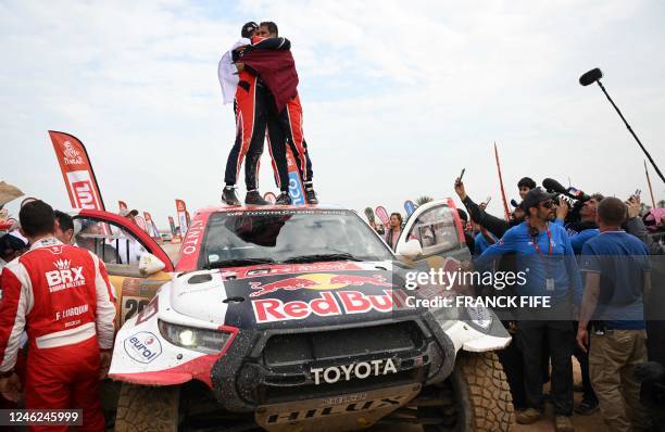 Toyota's driver Nasser Al-Attiyah of Qatar and his co-driver Mathieu Baumel of France celebrate their victory after winning the Dakar Rally 2023, at...