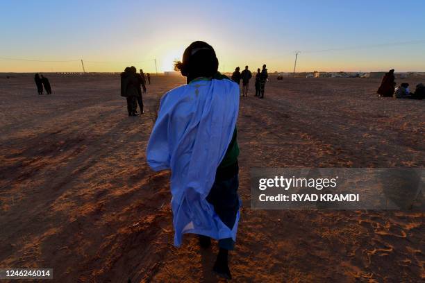 Displaced Sahrawis gather outside the refugee camp of Dakhla, which lies some 170km to the southeast of the Algerian city of Tindouf, on January 14,...