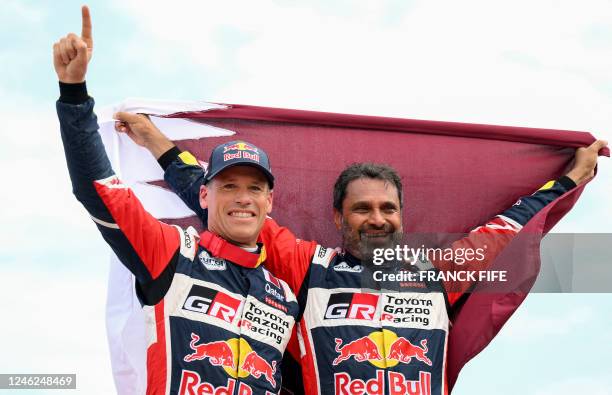 Toyota's driver Nasser Al-Attiyah of Qatar and his co-driver Mathieu Baumel of France celebrate after winning the Dakar Rally 2023, at the end of the...