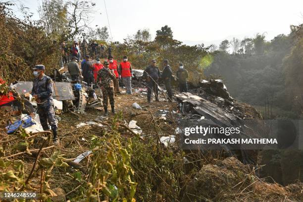 Rescuers gather at the site of a Yeti Airlines plane crash in Pokhara on January 15, 2023. - At least 67 people were confirmed dead on January 15...