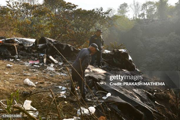 Rescuers inspect the wreckage at the site of a Yeti Airlines plane crash in Pokhara on January 15, 2023. - At least 67 people were confirmed dead on...