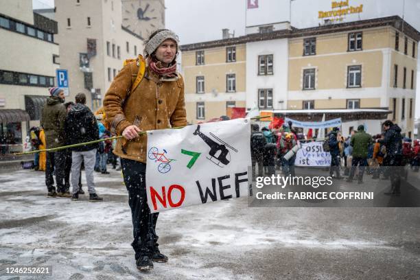 Young Socialists Switzerland activists take part in a protest against the World Economic Forum , calling for a climate tax on the rich, on the eve of...