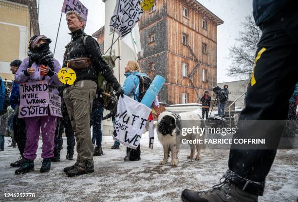 Young Socialists Switzerland activists take part in a protest against the World Economic Forum , calling for a climate tax on the rich, on the eve of...