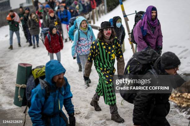 Young Socialists Switzerland activists take part in a protest against the World Economic Forum , calling for a climate tax on the rich, on the eve of...