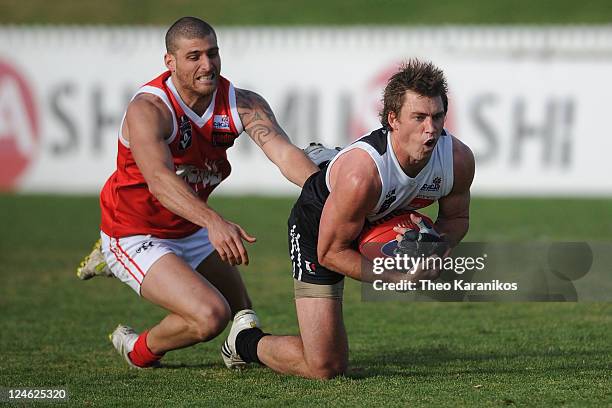 Daniel Pratt of the Roosters marks the ball in front of Paul Bower of the Bullants during the VFL Semi Final match between North Ballarat and...