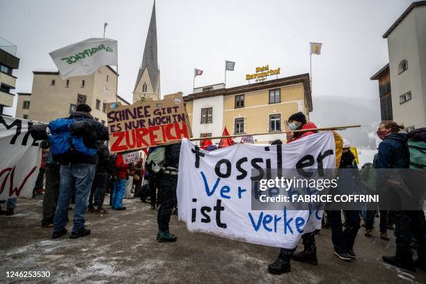 Young Socialists Switzerland activists take part in a protest against the World Economic Forum , calling for a climate tax on the rich, on the eve of...