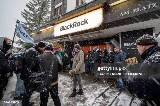 Young Socialists Switzerland activists take part in a protest against US investment company BlackRock calling for a climate tax on the rich, on the...