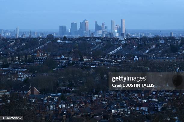 View of residential properties with the skyline of London's financial district behind, seen from Alexandra Palace in London on January 15, 2023.