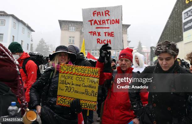 Activists take part in a protest to raise awareness on climate change and environment prior to the WEF annual meeting to be held from January 16 to...