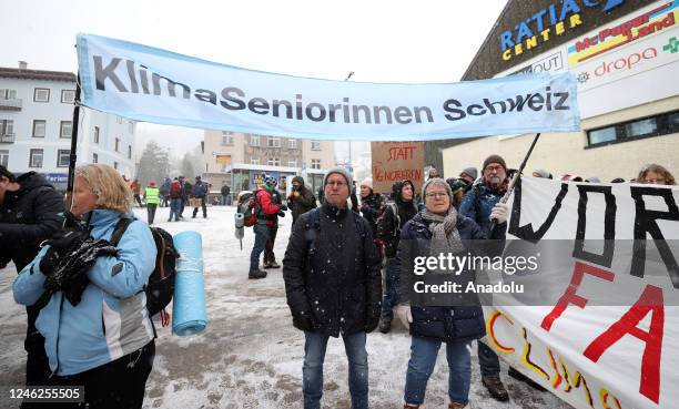 Activists take part in a protest to raise awareness on climate change and environment prior to the WEF annual meeting to be held from January 16 to...