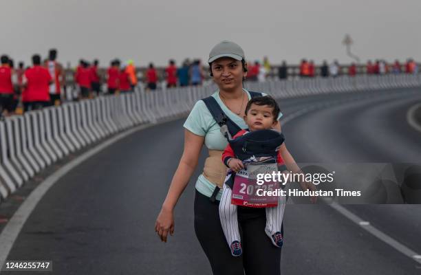 Avani from Kalyan with her baby passing on the Bandra worli sea link during the Tata Mumbai Marathon on January 15, 2023 in Mumbai, India.