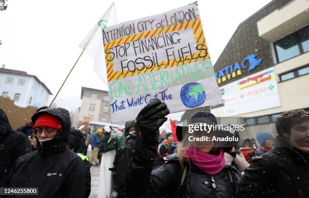 Activists take part in a protest to raise awareness on climate change and environment prior to the WEF annual meeting to be held from January 16 to...