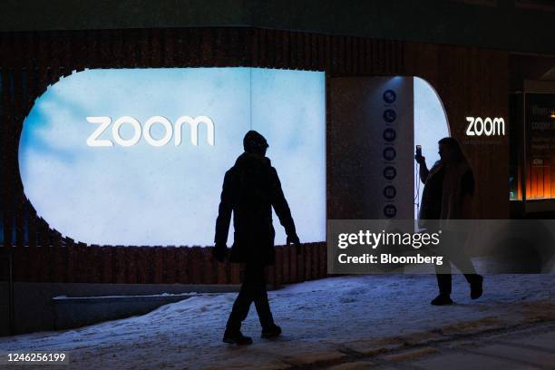 Pedestrian takes a picture of the Zoom Video Communications Inc. Pavilion ahead of the World Economic Forum in Davos, Switzerland, on Sunday, Jan....