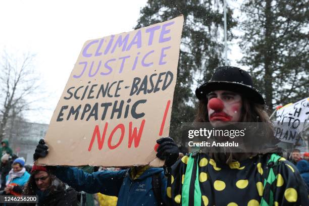 Activists take part in a protest to raise awareness on climate change and environment prior to the WEF annual meeting to be held from January 16 to...