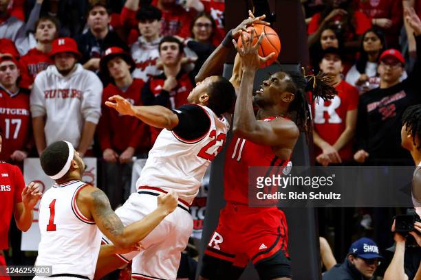 Clifford Omoruyi of the Rutgers Scarlet Knights pulls a rebound away from Zed Key of the Ohio State Buckeyes during the first half of a game at...