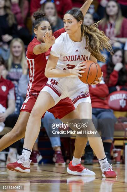Alyssa Geary of the Indiana Hoosiers handles the ball against Sania Copeland of the Wisconsin Badgers at Simon Skjodt Assembly Hall on January 15,...