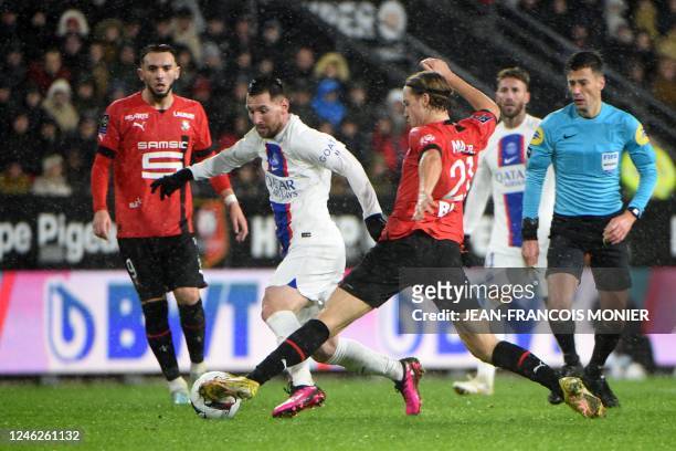 Paris Saint-Germain's Argentine forward Lionel Messi fights for the ball with Rennes' Croatian midfielder Lovro Majer during the French L1 football...
