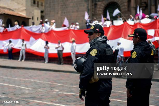 Riot police stand guard athe Plaza de Armas in Cusco, Peru on January 15 as residents carry out a rally for peace in memory of the 42 people that...