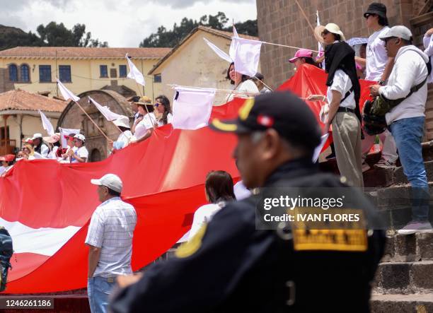 Riot police stand guard athe Plaza de Armas in Cusco, Peru on January 15 as residents carry out a rally for peace in memory of the 42 people that...