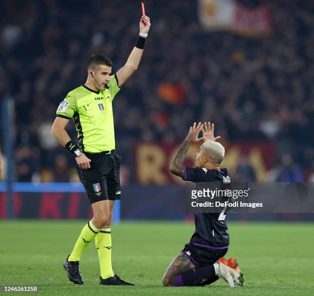 Dodo of ACF Fiorentina receives the yellow card by the referee Antonio Giua during the Serie A match between AS Roma and ACF Fiorentina at Stadio...