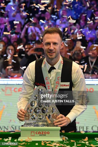 England's Judd Trump poses with the trophy after his victory over Wales' Mark Williams in the Masters snooker tournament final at Alexandra Palace in...