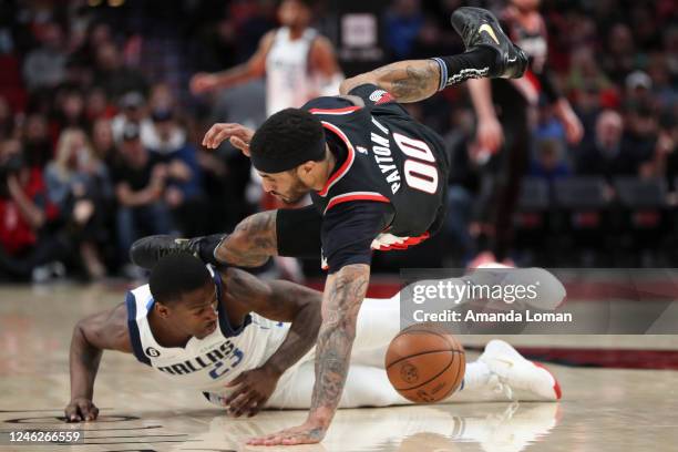 McKinley Wright IV of the Dallas Mavericks and Gary Payton II of the Portland Trail Blazers scramble for the ball during the first quarter at Moda...