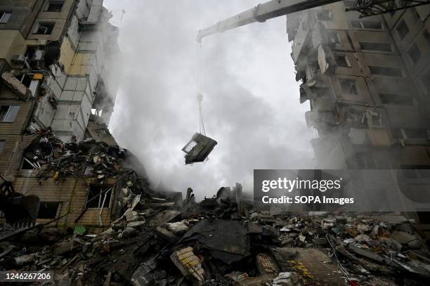 Rescuers dismantle the rubble of a destroyed house that was damaged as a result of a missile attack by the Russian army. On January 14, the Russian...