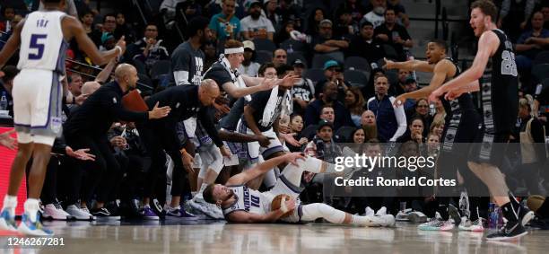 Domantas Sabonis of the Sacramento Kings takes a hard foul from the San Antonio Spurs in the second half at AT&T Center on January 15, 2023 in San...