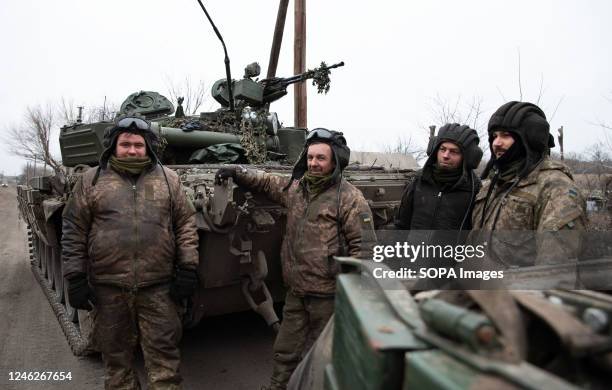 Ukrainian servicemen take a break outside the tank in the vicinity of the destroyed city of Slovyansk, liberated 3 months ago from Russian occupation...