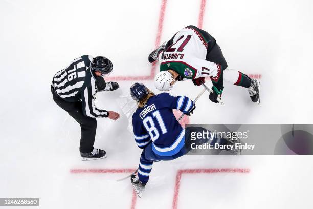 Kyle Connor of the Winnipeg Jets takes a second period face-off against Nick Bjugstad of the Arizona Coyotes at the Canada Life Centre on January 15,...