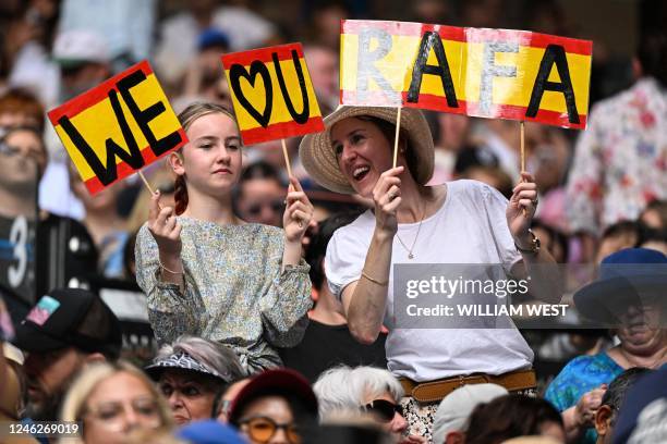 Supporters of Spain's Rafael Nadal hold up a sign during his men's singles match against Britain's Jack Draper on day one of the Australian Open...