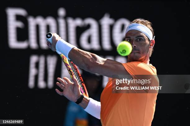 Spain's Rafael Nadal hits a return against Britain's Jack Draper during their men's singles match on day one of the Australian Open tennis tournament...