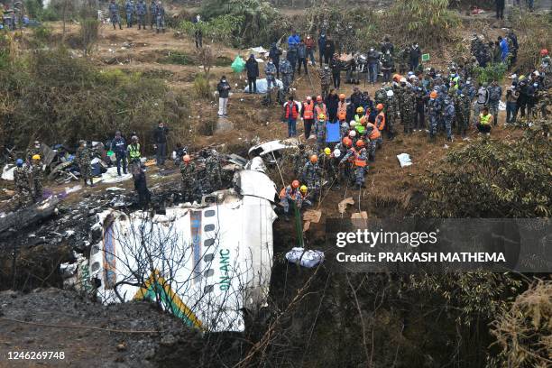 Graphic content / Rescuers pull the body of a victim who died in a Yeti Airlines plane crash in Pokhara on January 16, 2023. - Nepal observed a day...