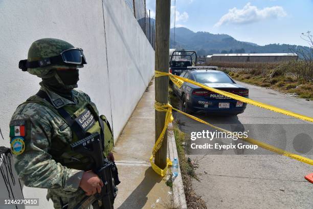Forensic experts for the State of Mexico investigate a secret grave inside an industrial warehouse where at least 26 packages with human remains were...