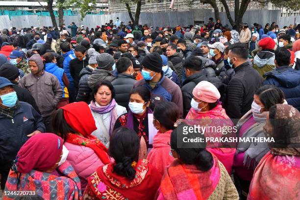 Family members and relatives of victims who died in a Yeti Airlines plane crash, gather outside a hospital in Pokhara on January 16, 2023. - Nepali...