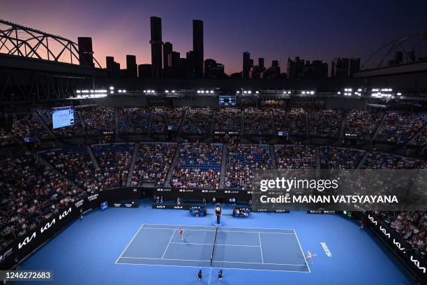 This picture shows a general view at sunset of the Rod Laver Arena during the women's singles match between Poland's Iga Swiatek and Germany's Jule...