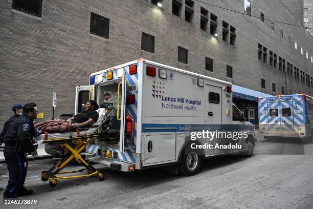 Health care workers carry a patient with a stretcher in New York, United States on January 10, 2023. A strike at two New York City hospitals that saw...