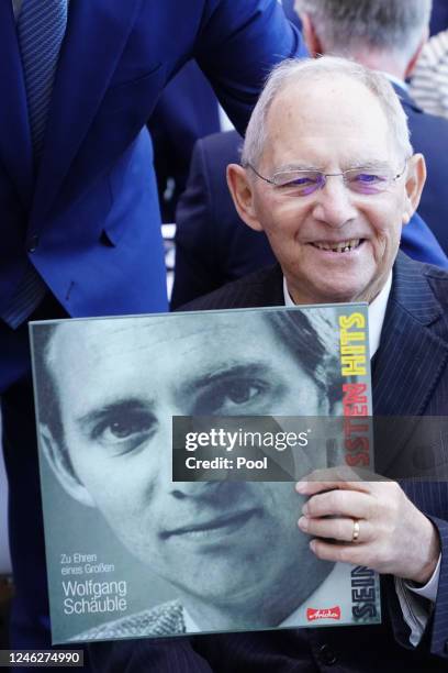 Former German Parliament Bundestag president Wolfgang Schaeuble poses with a record with one of his early speeches, he received as a present from...