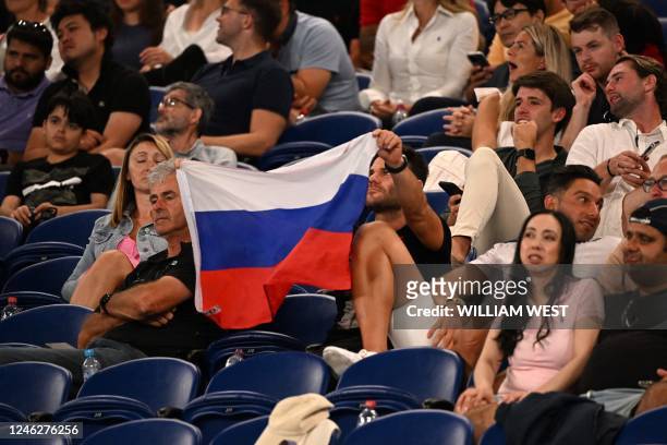 Supporter holds a flag of Russia during the men's singles match between Marcos Giron of the US and Russia's Daniil Medvedev on day one of the...