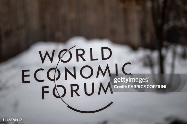 Photograph shows a sign of the World Economic Forum at the Congress centre on the opening day of the World Economic Forum annual meeting in Davos on...