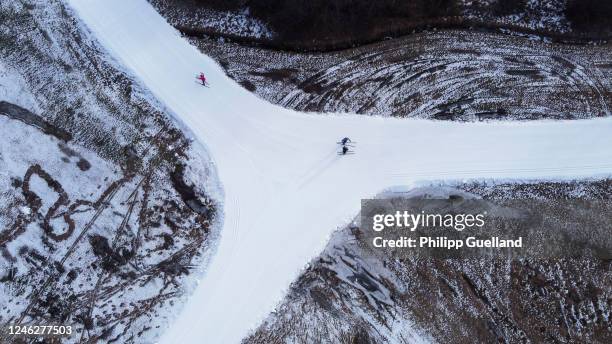 In this aerial view cross country skiers make their way along a track of artificial snow on January 16, 2023 near Ehrwald, Austria. Unseasonably warm...