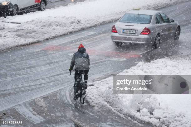 People at street after the first snowfall of the winter season in Ljubljana, Slovenia on January 16, 2023.