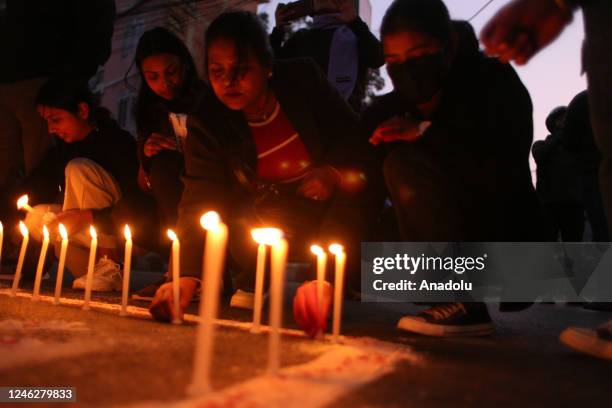 People place candles during a vigil in memory of victims of a plane crash of a Yeti Airlines operated aircraft in Pokhara on January 15 in Kathmandu,...
