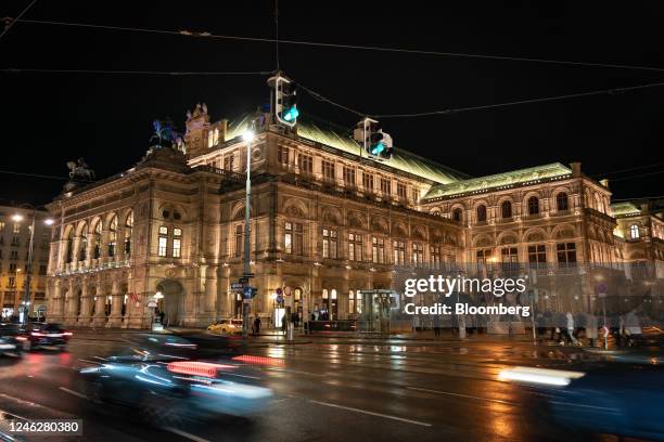 Traffic and pedestrians outside the Vienna State Opera house lit up at night in Vienna, Austria, on Sunday, Jan. 15, 2023. The European Central...