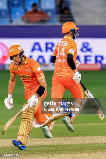 Gulf Giants' Gerhard Erasmus and James Vince run between the wickets during the International League T20 tournament cricket match between Dubai...