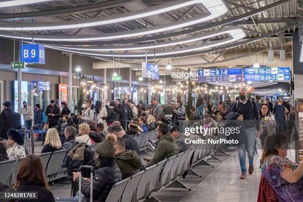 Passengers inside the departure hall early morning in the check-in area, waiting area and the gates in the terminal of Athens International Airport...